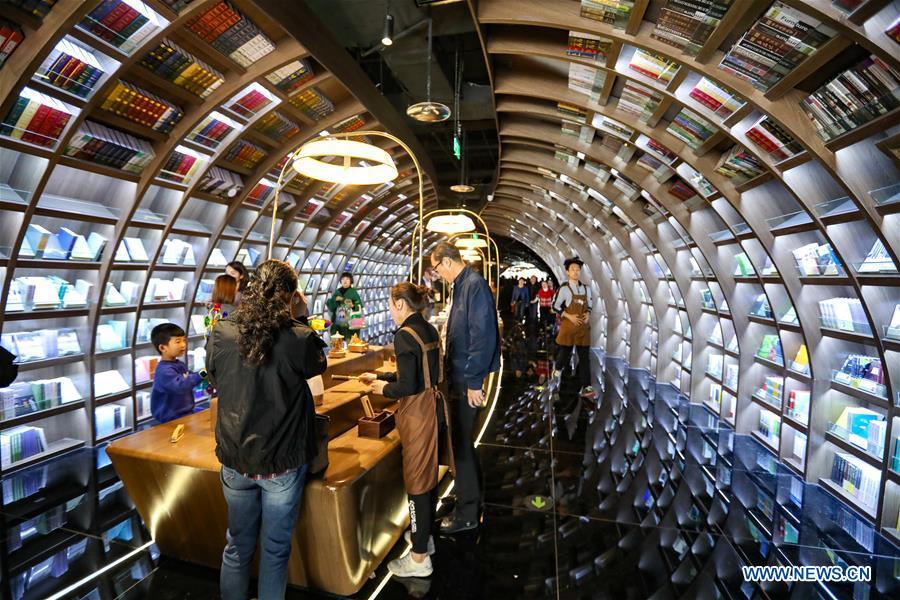 Readers browse at a bookstore named Zhongshuge in Guanshanhu District of Guiyang, southwest China\'s Guizhou Province, Oct. 28, 2018. The design of the bookstore Zhongshuge is inspired by the unique karst landform in Guizhou. (Xinhua/Liu Xu)