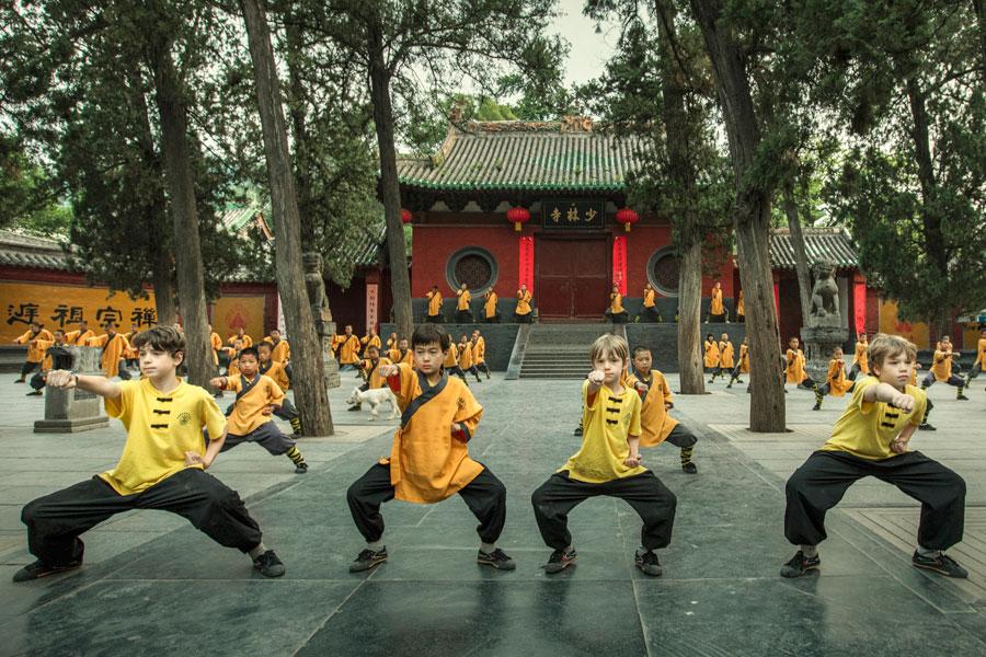 Foreign children practice martial arts at Shaolin Temple in Central China\'s Henan Province in June, 2017. (Photo by Li Tieqiang/For China Daily)