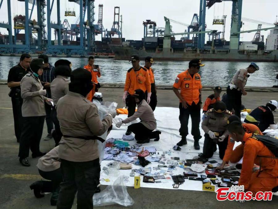 Rescue workers lay out recovered belongings believed to be from the crashed Lion Air flight JT610 at Tanjung Priok port in Jakarta, Indonesia, Oct. 30, 2018. Indonesia on Tuesday stepped up a search for an airliner that plunged into the sea with all 189 aboard feared dead, deploying underwater beacons to trace its black box recorders and uncover why an almost-new plane crashed minutes after take-off. (Photo: China News Service/Lin Yongchuan)