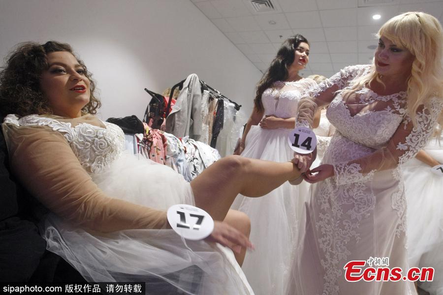 Beauty queens help each other backstage before taking to the catwalk in a bid to be crowned the winner of Miss Ukraine Plus Size at the competition in Kiev, Oct. 29, 2018. The winner will represent the country at the Miss World Plus Size pageant in the Philippines next month. (Photo/Sipaphoto)
