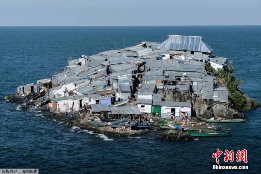 A picture taken on October 5, 2018, shows a general view of Migingo island which is densely populated by residents fishing mainly for Nile perch in Lake Victoria on the border of Uganda and Kenya. A rounded rocky outcrop covered in metallic shacks, Migingo Island rises out of the waters of Lake Victoria like an iron-plated turtle. The densely-populated island is barely a quarter of a hectare large, its residents crammed into a hodge-podge of corrugated-iron homes, with seemingly little but a few bars, brothels and a tiny port to boast of. (Photo/Agencies)
