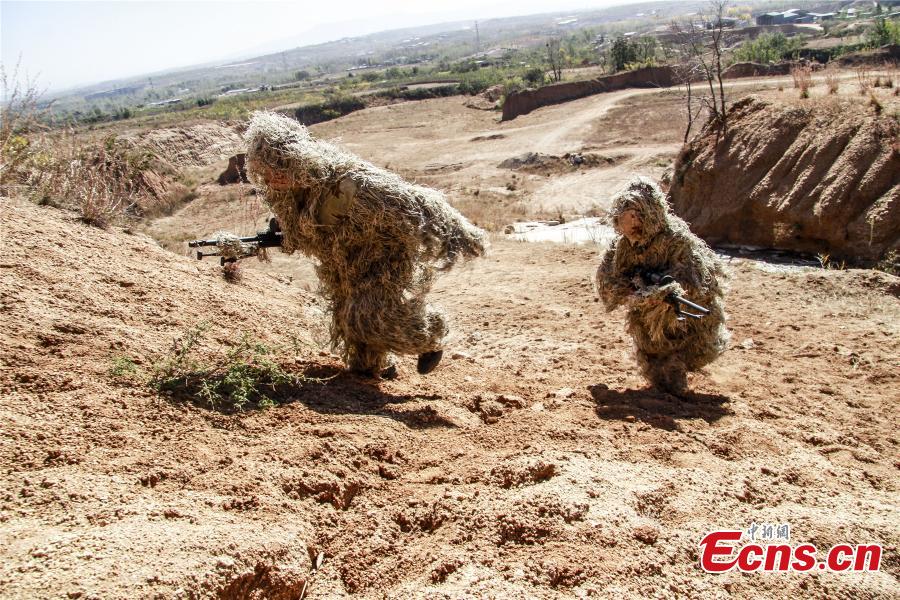 Snipers from a special unit of the Chinese People\'s Armed Police Force sharp their skills during a training at Songshan Mountain, Central China’s Henan province.  (Photo: China News Service/ Zhao Hongtao)