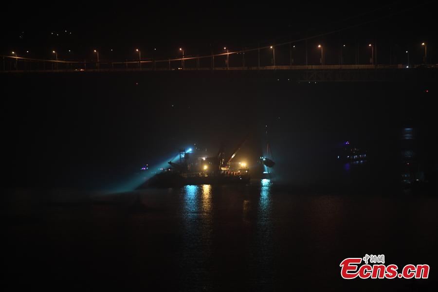 Rescuers on Wednesday night salvaged the wreck of a bus that plunged into the Yangtze River in Chongqing Municipality leaving at least nine people dead. The bus was pulled out of water by a floating crane at about 11:30 p.m.. Rescuers are expected to enter the bus to search for bodies of victims. The bus veered onto the wrong side of the road and collided into an oncoming car before breaking through road fencing and falling off a bridge in Chongqing\'s Wanzhou District on Sunday.(Photo: China News Service/ Chen Chao)