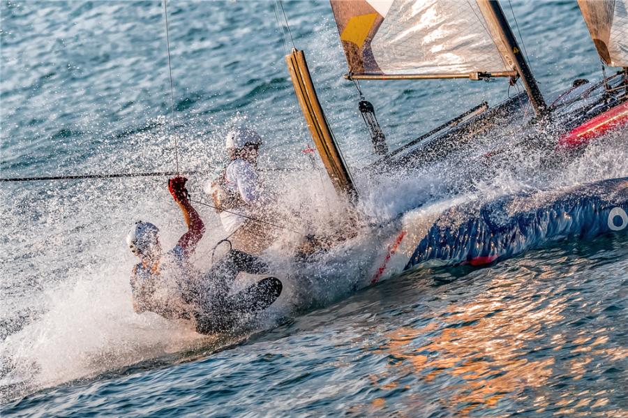 Sailors steer a two-man catamaran as water splashes during the 2018 Extreme Sailing Series Qingdao Mazarin Cup. (Photo by Zhong Weihua/for chinadaily.com.cn)

The 2018 Extreme Sailing Series Qingdao Mazarin Cup unveiled on Wednesday the award-winning photography of the event.

Selected through a contest, the photos captured moments from the 12-strong international Flying Phantom fleet during the sailing competition in Qingdao, Shandong Province, held from Sept. 30 to Oct. 3.

The Extreme Sailing Series, established in 2007, is the original Stadium Racing sailing circuit designed for spectators, delivering high-performance action close to the shore and putting guests at the heart of the battle.

The event has bolstered the coastal city of Qingdao\'s reputation as the home of Chinese sailing.
