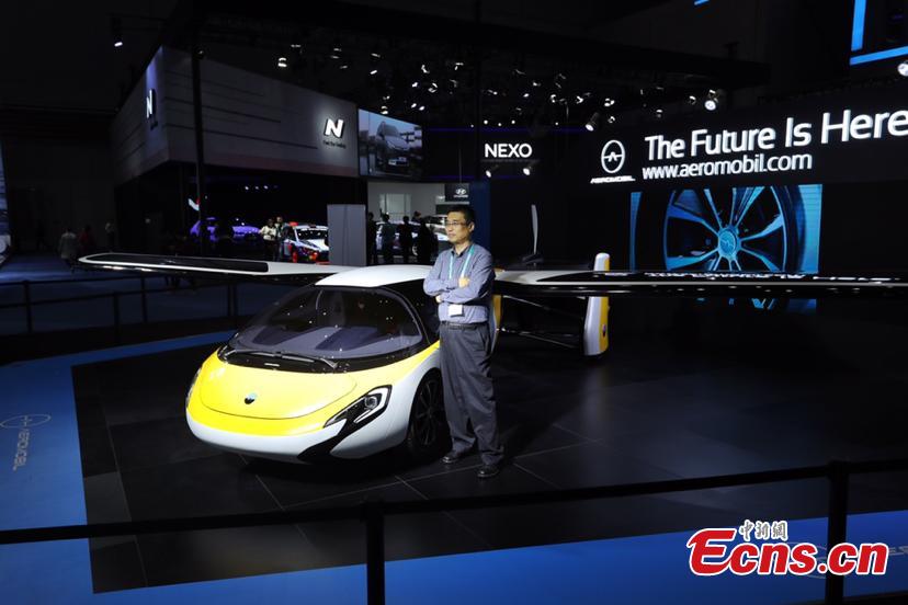 A flying car developed by AeroMobil, a Slovakian advanced engineering company is shown at the China International Import Expo (CIIE) opened in Shanghai on November 5, 2018. Integrating innovation in automotive and aerospace fields, the car with wings applies automotive safety standards together with lightweight materials and advanced aerodynamics. This will provide owners with true freedom of movement in the air and on the ground, providing electric propulsion on the road coupled with a lightweight internal combustion engine to provide propulsion in the air. (Photo: China News Service/ Zhang Hengwei)