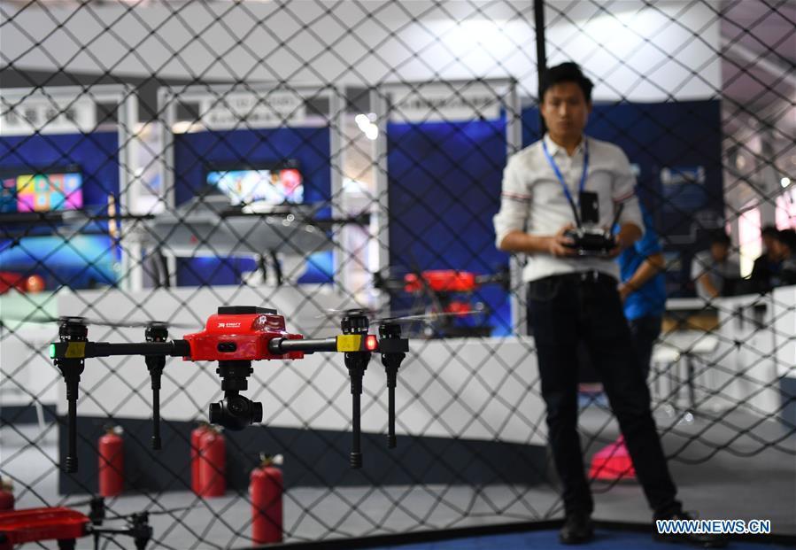 A staff member tests a drone at the UAV (unmanned aerial vehicle) exhibition area of the upcoming China International Aviation and Aerospace Exhibition in Zhuhai, south China\'s Guangdong Province, Nov. 5, 2018. The exhibition is scheduled to be held on Nov. 6-11. (Xinhua/Deng Hua)