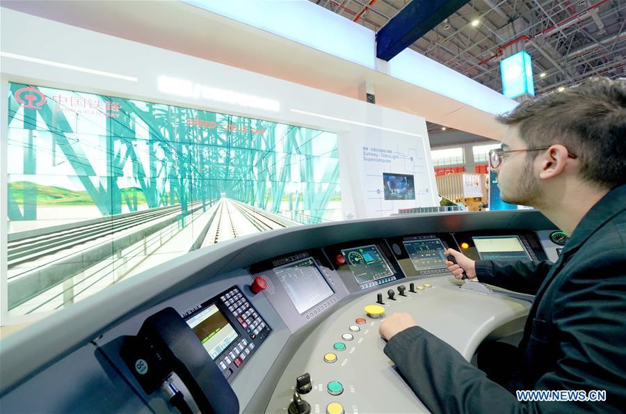 A member of Georgia\'s government delegation experiences a simulation of high-speed train driving at the China Pavilion during the first China International Import Expo (CIIE) in Shanghai, east China, Nov. 5, 2018. A total of 82 countries and three international organizations showcased their achievements in economic and trade development as well as competitive products at 71 booths in the Country Pavilion for Trade and Investment at the CIIE. (Xinhua/Chen Jianli)