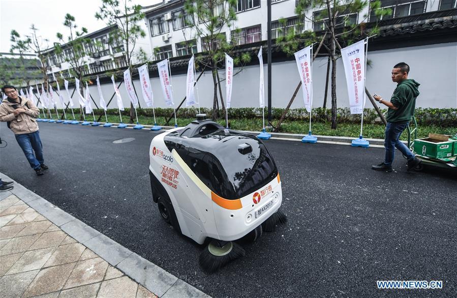 An automatic cleaning robot is at work during the Light of Internet Expo of the fifth World Internet Conference in Wuzhen Township of Tongxiang, east China\'s Zhejiang Province, Nov. 6, 2018. Opening here on Tuesday, the exposition focuses on the world\'s most recent internet development trends and cutting-edge technologies, showing the latest internet technologies, achievements, products and applications of more than 430 enterprises and institutions from home and abroad. (Xinhua/Xu Yu)