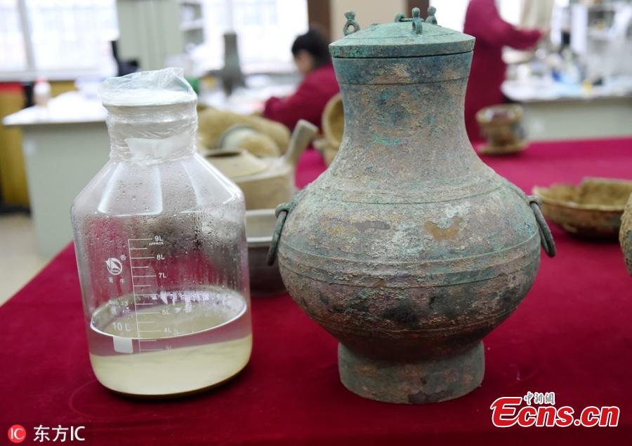 Archaeologists in central China\'s Henan Province on Tuesday poured liquid out of a bronze pot unearthed from a Western Han Dynasty (202 BC to AD 8) tomb into a measuring glass, which gave off an aroma of rich wine. \