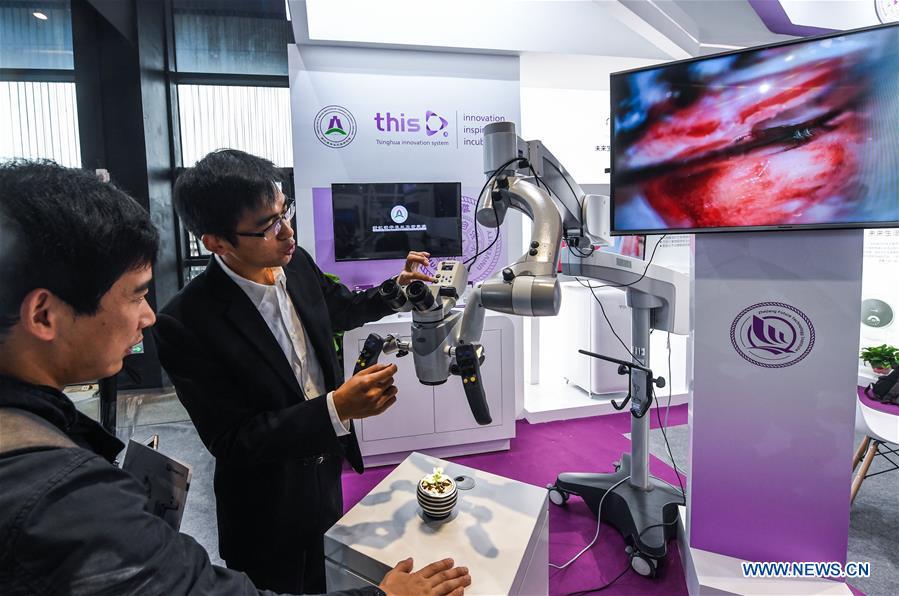 An exhibitor shows a 3D high-definition surgical microscopic video camera system at the Light of Internet Expo of the fifth World Internet Conference in Wuzhen Township of Tongxiang, east China\'s Zhejiang Province, Nov. 6, 2018. Opening here on Tuesday, the exposition focuses on the world\'s most recent internet development trends and cutting-edge technologies, showing the latest internet technologies, achievements, products and applications of more than 430 enterprises and institutions from home and abroad. (Xinhua/Xu Yu)