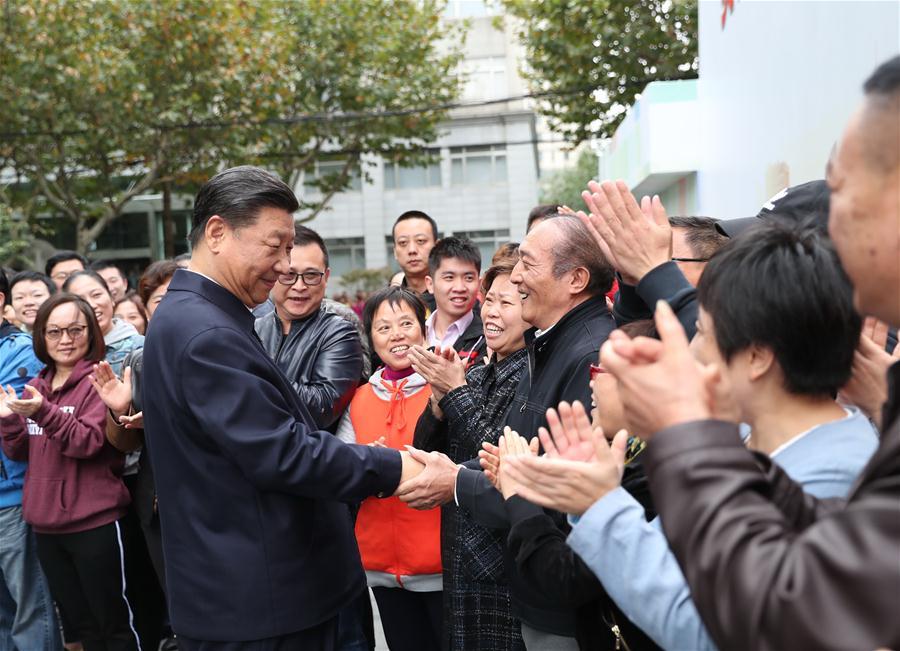 Chinese President Xi Jinping, also general secretary of the Communist Party of China Central Committee and chairman of the Central Military Commission, shakes hands with local residents at a community center in Hongkou District of east China\'s Shanghai, Nov. 6, 2018. Xi Jinping made a two-day inspection in Shanghai, which ended on Wednesday. (Xinhua/Xie Huanchi)