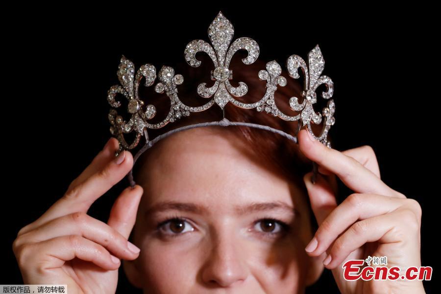 A model holds a diamond tiara part of the collection of Charles X the last king of France during a press preview ahead of the upcoming auction \