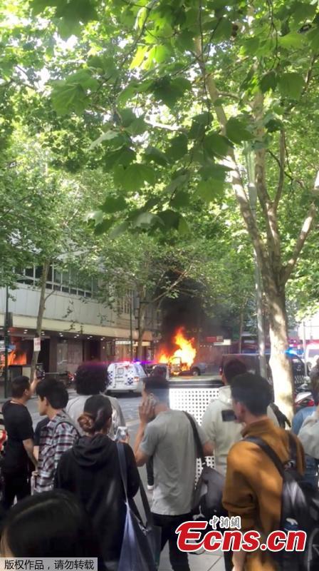 A burning car is seen near the Bourke Street mall, in Melbourne, Australia, November 9, 2018 in this picture grab obtained from social media video. Australian police reported multiple people were hurt after a man set a car on fire and allegedly stabbed a number of people in Melbourne\'s Bourke St. (Photo/Agencies)