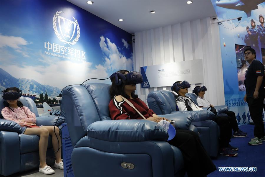 Visitors experience VR sets at the 12th China International Aviation and Aerospace Exhibition (Airshow China) in Zhuhai, south China\'s Guangdong Province, Nov. 10, 2018. Saturday marks the second of three public days of the Airshow China. (Xinhua/Liu Fang)