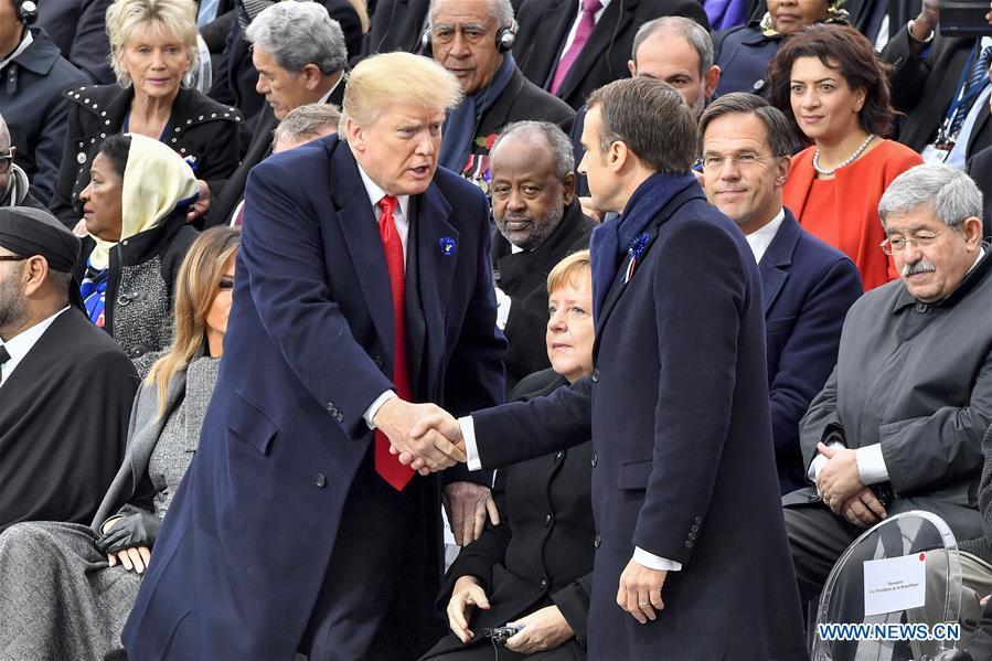 French President Emmanuel Macron (R, Front) shakes hands with U.S. President Donald Trump during a ceremony to mark the centenary of the Armistice of the First World War in Paris, France, Nov. 11, 2018. (Xinhua/Chen Yichen)