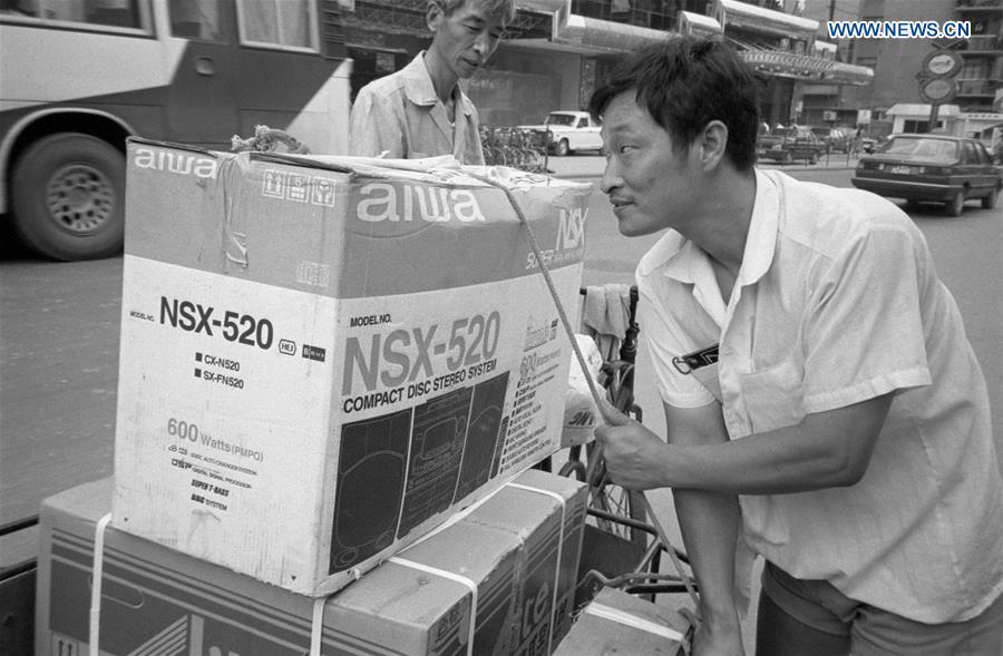 Undated photo shows a citizen transporting a Japanese-made Aiwa acoustic equipment in Shanghai, east China. (Xinhua/Zhang Ming)