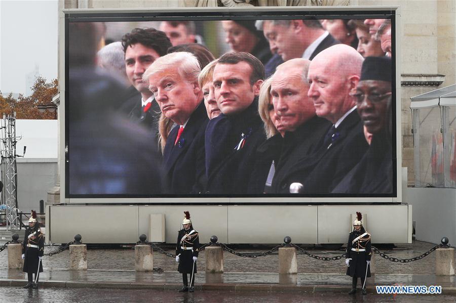 A screen in front of the Arc de Triomphe shows the US President Donald Trump, German Chancellor Angela Merkel, French President Emmanuel Macron, Russian President Vladimir Putin and other politicians attend the ceremony to commemorate the 100th anniversary of the end of World War I in Paris, France, Nov. 11, 2018. (Xinhua/Zheng Huansong)