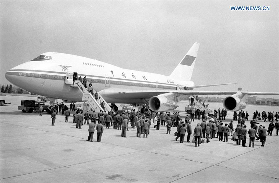 Undated photo shows passengers disembarking from a Boeing airliner. The Civil Aviation Administration of China (CAAC) in 1980 put into use a Boeing 747SP airliner, the first of such a move. (Xinhua/Song Lianfeng)