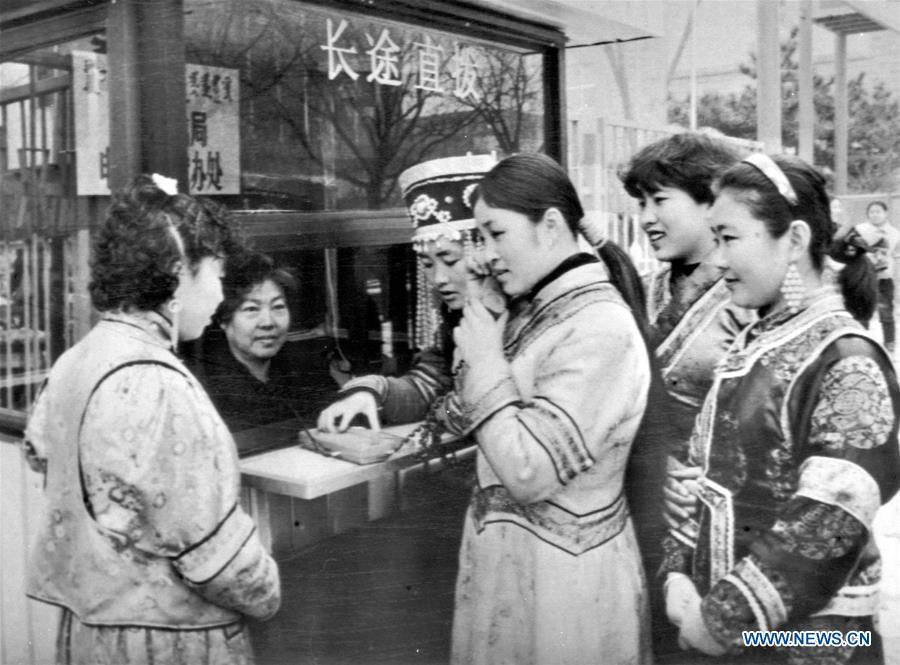 A woman of Mongolia ethnic group makes a long-distance phone call at a public phone booth in Hohhot, north China\'s Inner Mongolia Autonomous Region, Dec. 7, 1992. More than four decades of sound economic growth from 1978, the starting year of the reform and opening-up policy, has fundamentally lifted life quality of 1.3 billion Chinese, who are now able to enjoy the \