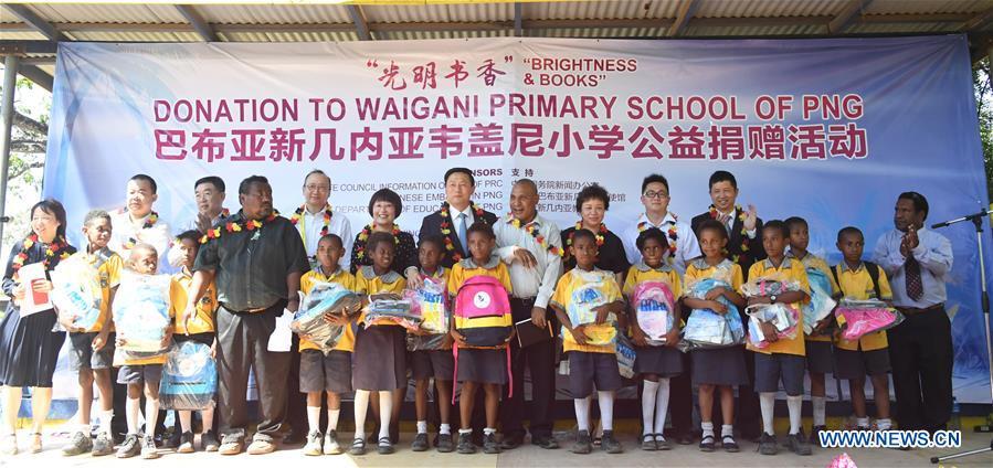 Guo Weimin (C), deputy director of the State Council Information Office of China, attends a donation ceremony to a local primary school in Port Moresby, Papua New Guinea, on Nov. 12, 2018. A series of cultural exchange activities were held here on Monday between China and Papua New Guinea (PNG) ahead of the Asia-Pacific Economic Cooperation (APEC) Leaders\' Meeting. (Xinhua/Lui Siu Wai)