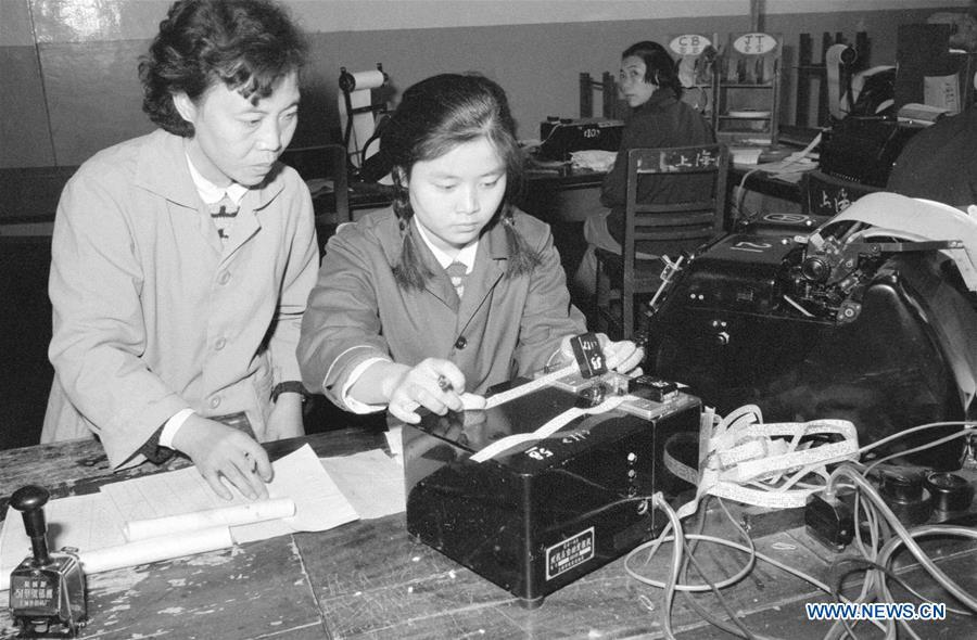 File photo taken in 1979 shows Luo Sufang guiding a new staff to send telegram at Chengdu telecom bureau in Chengdu, southwest China\'s Sichuan Province. More than four decades of sound economic growth from 1978, the starting year of the reform and opening-up policy, has fundamentally lifted life quality of 1.3 billion Chinese, who are now able to enjoy the \
