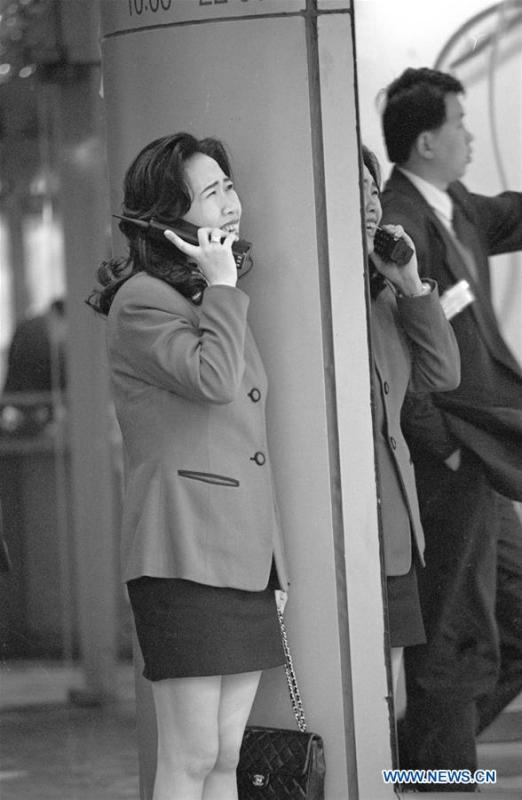 Photo taken in January of 1995 shows a woman using a brick-size cellular phone in Shanghai, east China. Shanghai had about 70,000 users of mobile phone in 1995. More than four decades of sound economic growth from 1978, the starting year of the reform and opening-up policy, has fundamentally lifted life quality of 1.3 billion Chinese, who are now able to enjoy the \