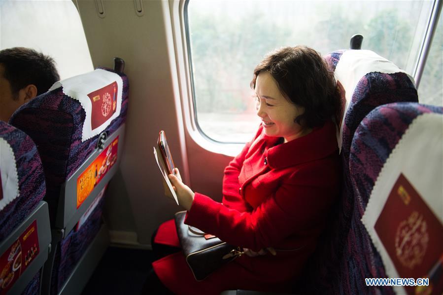 A passenger talks with her friend through a phone video call using 4G network on a bullet train from Hefei, east China\'s Anhui Province, to Jiangshan, east China\'s Zhejiang Province, Feb. 4, 2015. High-speed railways in Anhui started to offer 4G service to passengers during the Spring Festival travel rush in 2015. More than four decades of sound economic growth from 1978, the starting year of the reform and opening-up policy, has fundamentally lifted life quality of 1.3 billion Chinese, who are now able to enjoy the \