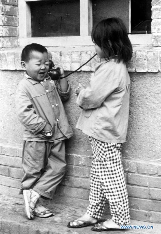 Photo taken on May 10, 1983 shows children making phone call with parents at a public phone booth in central China\'s Henan Province. More than four decades of sound economic growth from 1978, the starting year of the reform and opening-up policy, has fundamentally lifted life quality of 1.3 billion Chinese, who are now able to enjoy the \