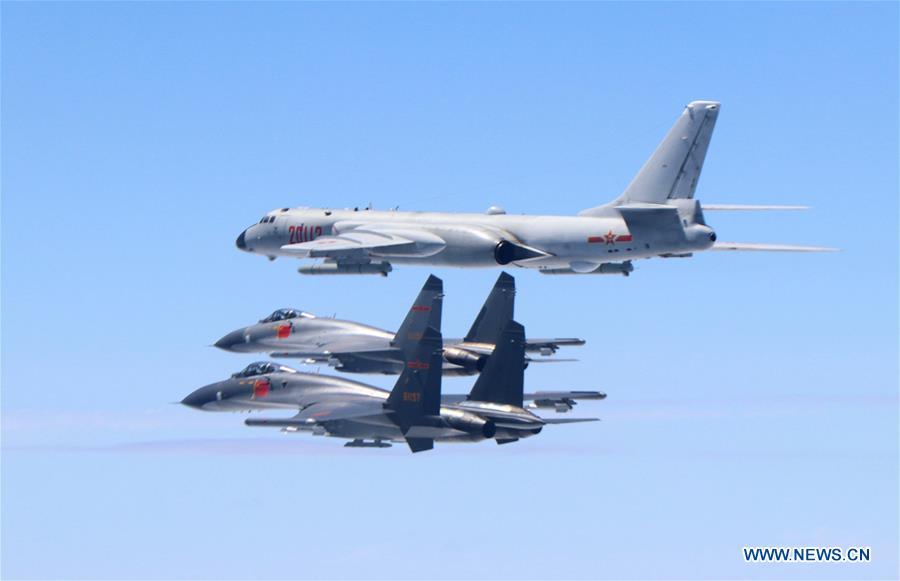 Two J-11 fighter jets and a H-6K bomber fly in formation on May 11, 2018. The Chinese Air Force announced a roadmap for building a stronger modern air force in three steps. The building of a stronger modern air force is in line with the overall goal of building national defense and the armed forces, Lieutenant General Xu Anxiang, deputy commander of Chinese Air Force, said at a press conference on celebrating the 69th anniversary of the establishment of Chinese Air Force held in Zhuhai, south China\'s Guangdong Province, Nov. 11, 2018. (Xinhua/Shao Jing)