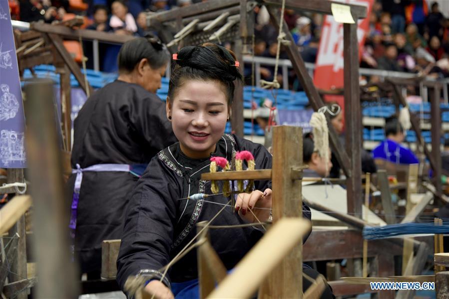 A competitor presents spinning skills during a manual skills competition held in Rongjiang County of Qiandongnan Miao and Dong Autonomous Prefecture, southwest China\'s Guizhou Province, on Nov. 15, 2018. A number of artisans from the county participated in the competition in aspects of spinning, weaving, wax printing, embroidery and so on. (Xinhua/Liu Jinyin)