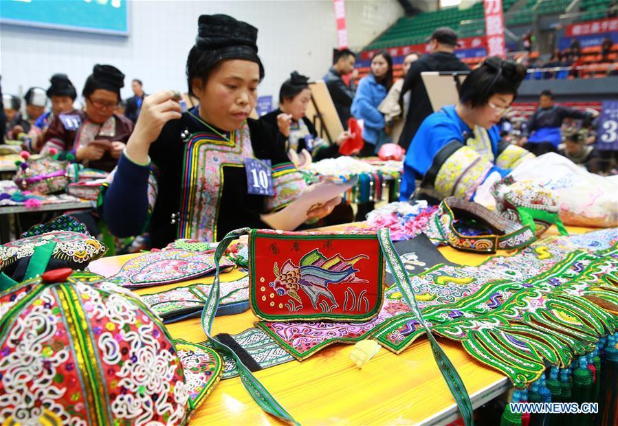 Competitors present embroidery skills during a manual skills competition held in Rongjiang County of Qiandongnan Miao and Dong Autonomous Prefecture, southwest China\'s Guizhou Province, on Nov. 15, 2018. A number of artisans from the county participated in the competition in aspects of spinning, weaving, wax printing, embroidery and so on. (Xinhua/Li Changhua)