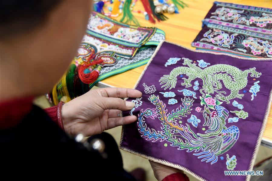 A competitor presents embroidery skills during a manual skills competition held in Rongjiang County of Qiandongnan Miao and Dong Autonomous Prefecture, southwest China\'s Guizhou Province, on Nov. 15, 2018. A number of artisans from the county participated in the competition in aspects of spinning, weaving, wax printing, embroidery and so on. (Xinhua/Liu Jinyin)