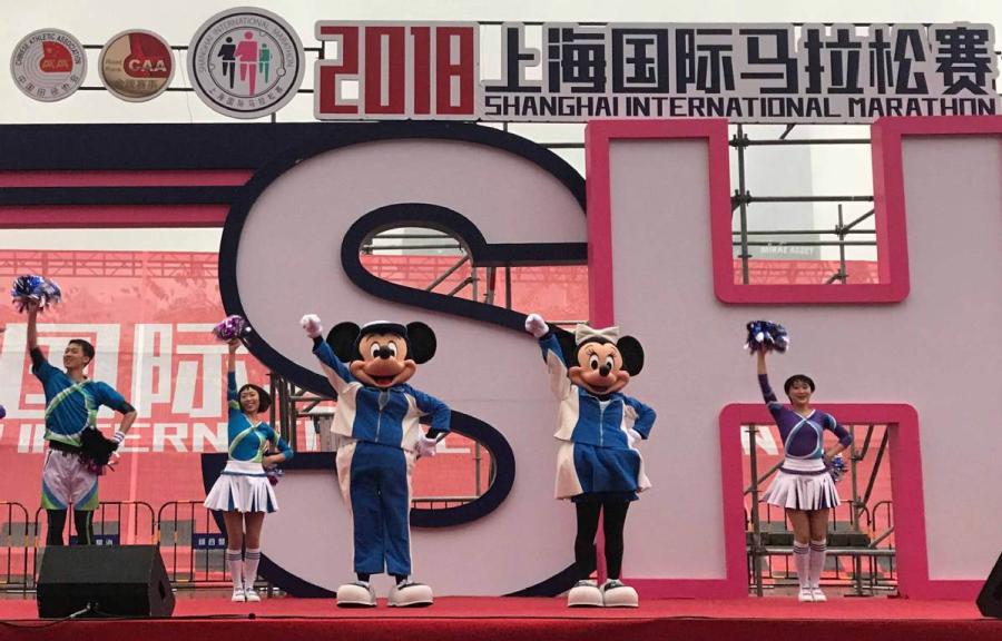 Mickey and its companion Minnie Mouse make a surprise visit to the Shanghai International Marathon on Nov. 18.