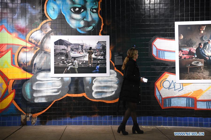A visitor views photographs exhibited at the World Press Photo Exhibition 2018 at Dupont Underground in Washington D.C., the United States, Nov. 19, 2018. The exhibition, which is held from Oct. 27 to Nov. 25, showcases the winning photographs from the 61st annual World Press Photo contest, which received over 70,000 photographs taken by 4,548 photographers. (Xinhua/Liu Jie)