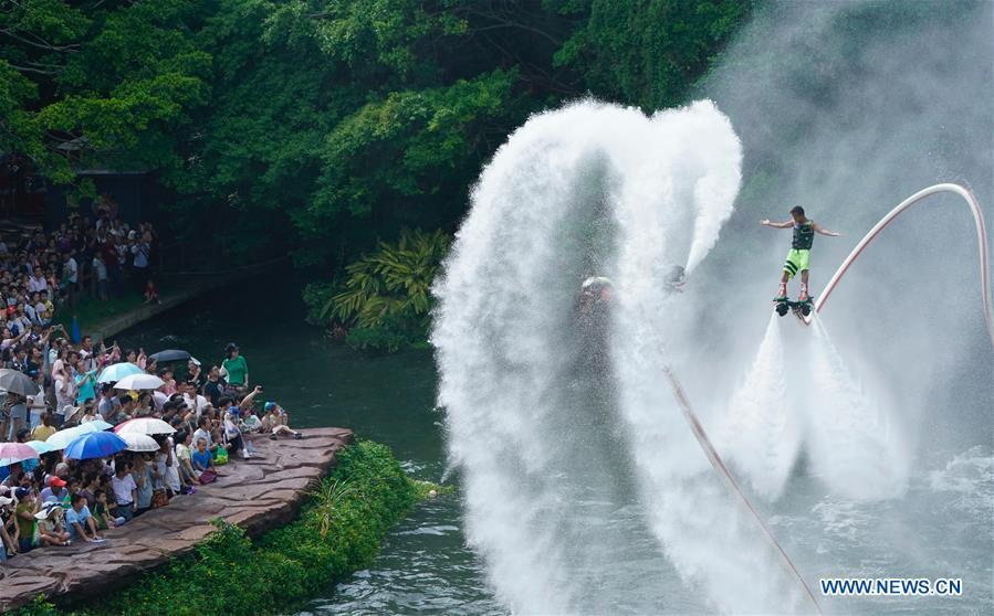 Visitors watch performance at a theme park in Shenzhen City of south China\'s Guangdong Province, Oct. 4, 2017. China is slated to become world\'s largest theme park market by 2020, when the number of tourists is expected to exceed 230 million, according to a fresh report by U.S. engineering firm AECOM. The number of tourists to Chinese theme parks have seen an average annual growth of 13 percent in the past decade, and reached 190 million in 2017. The number is expected to keep the double digit growth in the following years, according to the report. The report attributes the rapid growth to Chinese consumers\' rising income that sparks greater demands on leisure activities, as well as more convenient public transportation systems. (Xinhua/Mao Siqian)