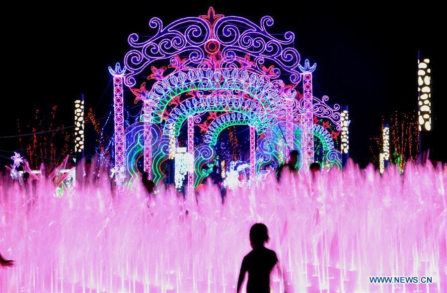 Tourists enjoy colorful lights during a light art festival held at a space theme park in Yanjiao of Sanhe City, north China\'s Hebei Province, July 29, 2016. China is slated to become world\'s largest theme park market by 2020, when the number of tourists is expected to exceed 230 million, according to a fresh report by U.S. engineering firm AECOM. The number of tourists to Chinese theme parks have seen an average annual growth of 13 percent in the past decade, and reached 190 million in 2017. The number is expected to keep the double digit growth in the following years, according to the report. The report attributes the rapid growth to Chinese consumers\' rising income that sparks greater demands on leisure activities, as well as more convenient public transportation systems. (Xinhua/Li Mingfang)