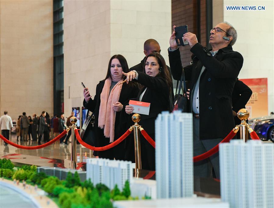 Foreign visitors view Shanghai\'s architectural models during a major exhibition to commemorate the 40th anniversary of China\'s reform and opening-up at the National Museum of China in Beijing, capital of China, Nov. 19, 2018. (Xinhua/Li He)