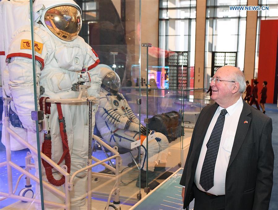 A foreign visitor views the spacesuits designed and made by China during a major exhibition to commemorate the 40th anniversary of China\'s reform and opening-up at the National Museum of China in Beijing, capital of China, Nov. 19, 2018. (Xinhua/Li He)