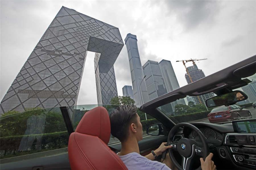 A young man drives a roadster through the CBD area in Beijing, Aug 5, 2018. (Photo provided to chinadaily.com.cn)