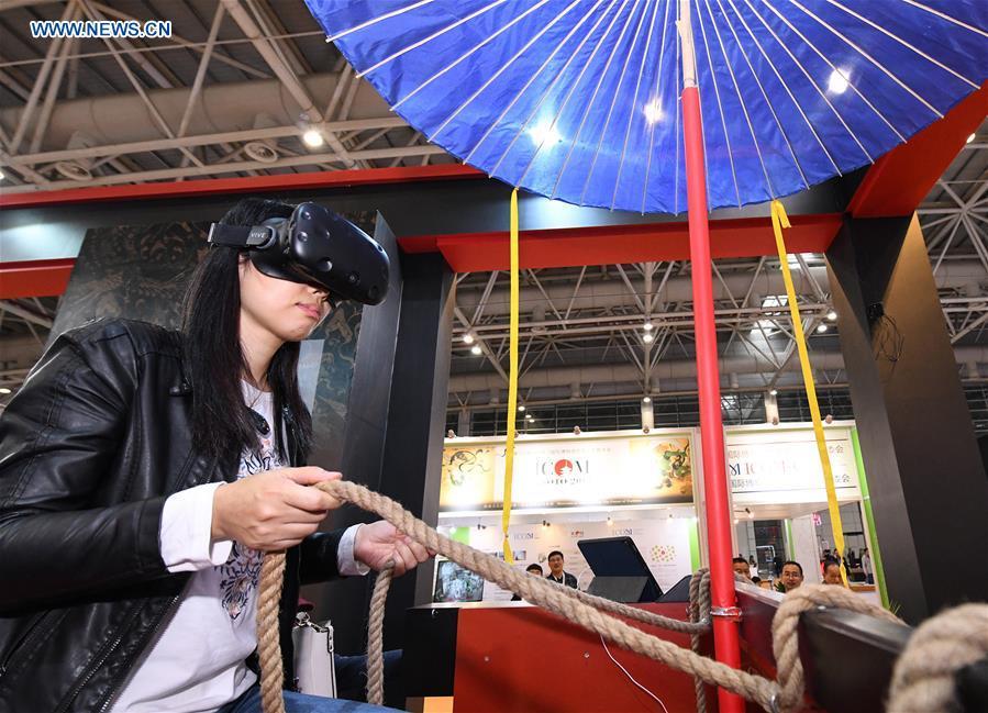 A visitor tries a virtual reality headset in the 8th Chinese Museums and Relevant Products and Technologies Exposition (MPT-Expo) in Fuzhou, capital of southeast China\'s Fujian Province, Nov. 23, 2018. (Xinhua/Li He)