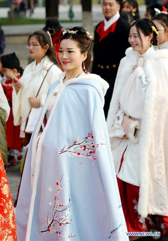 People wearing Hanfu, Chinese traditional costume, walk during an event at the Daming Palace National Heritage Park in Xi\'an, northwest China\'s Shaanxi Province, Nov. 24, 2018. More than 400 Hanfu lovers attended the event to promote traditional Chinese culture. (Xinhua/Liu Xiao)