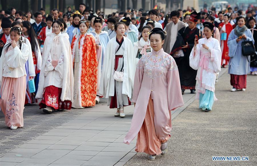People wearing Hanfu, Chinese traditional costume, walk during an event at the Daming Palace National Heritage Park in Xi\'an, northwest China\'s Shaanxi Province, Nov. 24, 2018. More than 400 Hanfu lovers attended the event to promote traditional Chinese culture. (Xinhua/Liu Xiao)