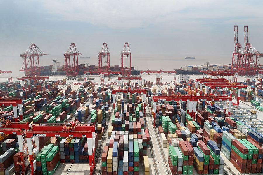 Cargo containers pack the Yangshan port in the Shanghai Pilot Free Trade Zone on May 17. (Photo/Xinhua)
New mission

About 40 years ago, China established special economic zones, which served as windows and testing grounds when the authorities decided to open the domestic market and modernize the country\'s economy.

Foreign investment flowed in, new regulations were issued and new technologies were tested first in these areas－later spreading to other parts of the country, contributing to the fast growth of China\'s economy over the years.

Observers see the establishment of pilot FTZs as a new move for China to push ahead reform and opening-up in a new domestic and external environment.

Compared with special economic zones, pilot FTZs aim to achieve mutual benefit and enable the country to participate in global economic cooperation and competition at a higher level, Luo Qinghe, a professor with Shenzhen University, wrote in a research paper.

A raft of measures have been taken for pilot FTZs to create a more investor-friendly business environment in support of fair competition.

The negative list for foreign investment, for instance, has been shortened in pilot FTZs to broaden market access. Over the past five years, the negative list has been shortened from 190 to 45 items in the Shanghai Pilot FTZ.

The Liaoning Pilot FTZ, the only pilot FTZ in Northeast China, upgraded the processes for examination and approval in the port of Dalian to facilitate the circulation of goods, with the cost for customs clearance slashed by 10 percent.

\