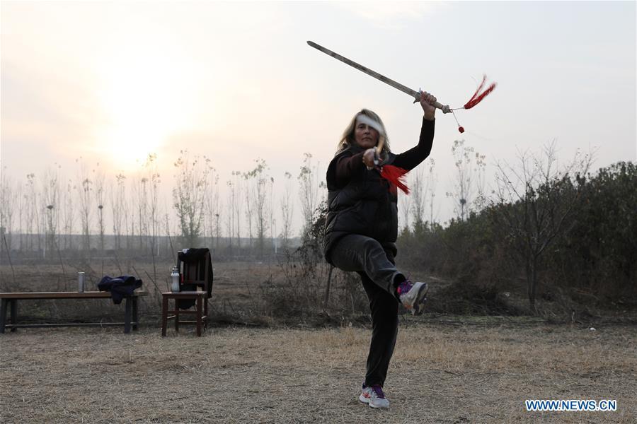 Ana Fidalgo practices Taiji swords in Chenjiagou Village of Wenxian County, central China\'s Henan Province, Nov. 25, 2018. Ana, who comes from Sao Paulo, Brazil, loves Chinese culture, and is a fan of Taiji. It\'s the third time that she comes to Chenjiagou Village to study Taiji. She has taught what she has learned in China in her hometown when coming back to Brazil in recent years, hoping to benefit more people. (Xinhua/Xu Hongxing)