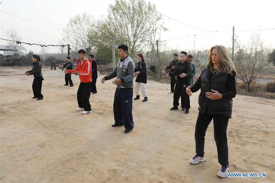 Ana Fidalgo (1st R) practices Taiji with other students in Chenjiagou Village of Wenxian County, central China\'s Henan Province, Nov. 25, 2018. Ana, who comes from Sao Paulo, Brazil, loves Chinese culture, and is a fan of Taiji. It\'s the third time that she comes to Chenjiagou Village to study Taiji. She has taught what she has learned in China in her hometown when coming back to Brazil in recent years, hoping to benefit more people. (Xinhua/Xu Hongxing)