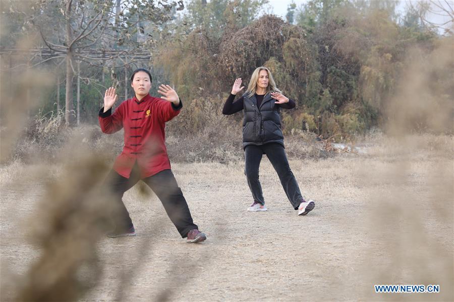 Ana Fidalgo (R) practices Taiji under the guidance of coach Chen Huili in Chenjiagou Village of Wenxian County, central China\'s Henan Province, Nov. 25, 2018. Ana, who comes from Sao Paulo, Brazil, loves Chinese culture, and is a fan of Taiji. It\'s the third time that she comes to Chenjiagou Village to study Taiji. She has taught what she has learned in China in her hometown when coming back to Brazil in recent years, hoping to benefit more people. (Xinhua/Xu Hongxing)
