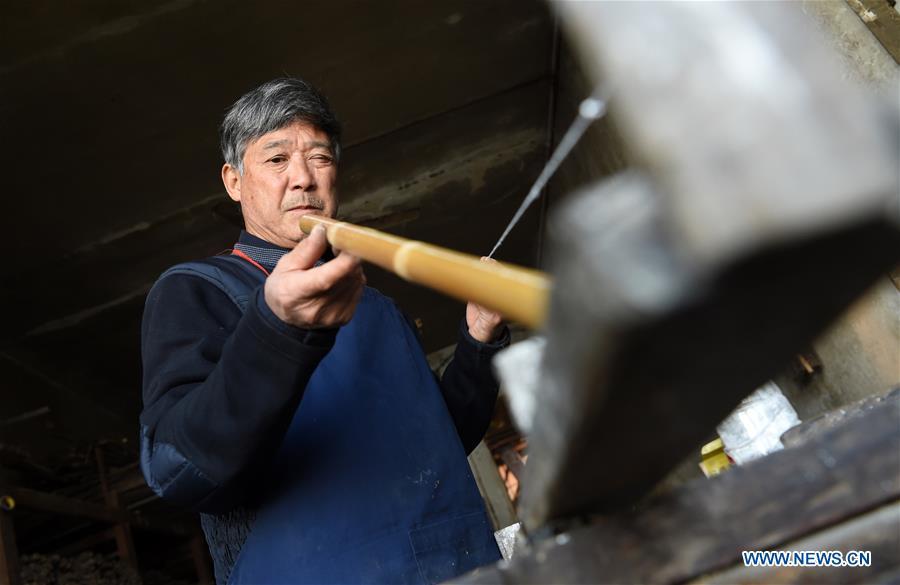 Liu Zesong, inheritor of the Yuping bamboo flute making craft, checks bamboo materials for making a flute in Yuping Dong Autonomous County, southwest China\'s Guizhou Province, Nov. 29, 2018. As a traditional Chinese bamboo instrument, Yuping bamboo flute is famous for its clear tone and delicate carving. Made from local bamboo, the flute goes through dozens of procedures before finished and merges folk cultures of other ethnic groups. It was listed as one of the National Intangible Cultural Heritages in 2006. (Xinhua/Ma Ning)