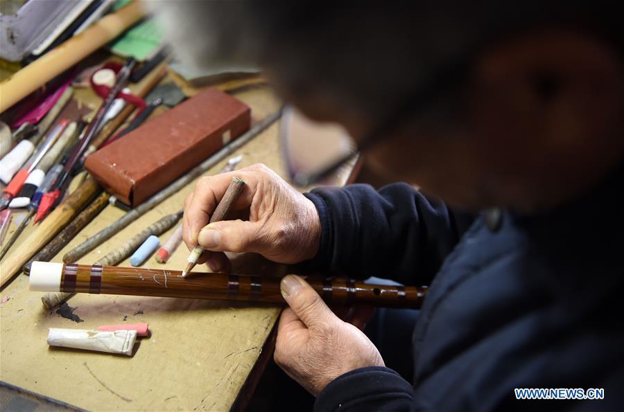 Liu Zesong, inheritor of the Yuping bamboo flute making craft, prepares for carving on a flute in Yuping Dong Autonomous County, southwest China\'s Guizhou Province, Nov. 29, 2018. As a traditional Chinese bamboo instrument, Yuping bamboo flute is famous for its clear tone and delicate carving. Made from local bamboo, the flute goes through dozens of procedures before finished and merges folk cultures of other ethnic groups. It was listed as one of the National Intangible Cultural Heritages in 2006. (Xinhua/Ma Ning)