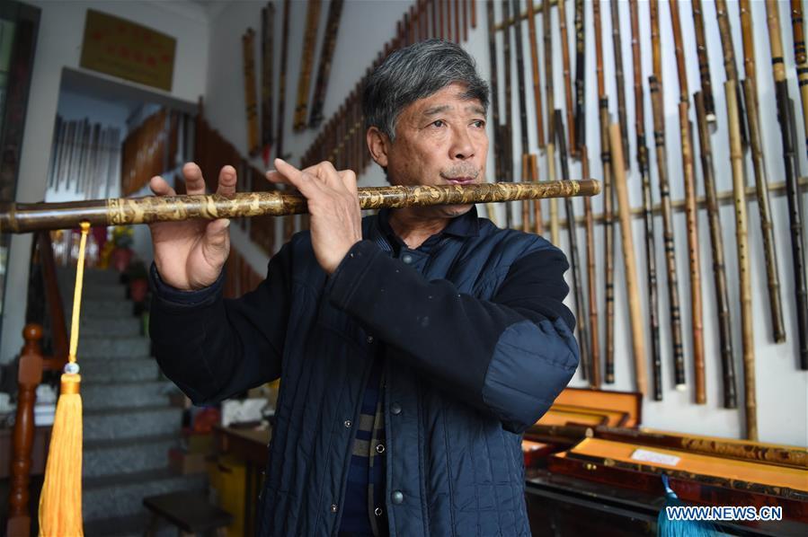 Liu Zesong, inheritor of the Yuping bamboo flute making craft, blows a flute he made in Yuping Dong Autonomous County, southwest China\'s Guizhou Province, Nov. 29, 2018. As a traditional Chinese bamboo instrument, Yuping bamboo flute is famous for its clear tone and delicate carving. Made from local bamboo, the flute goes through dozens of procedures before finished and merges folk cultures of other ethnic groups. It was listed as one of the National Intangible Cultural Heritages in 2006. (Xinhua/Ma Ning)