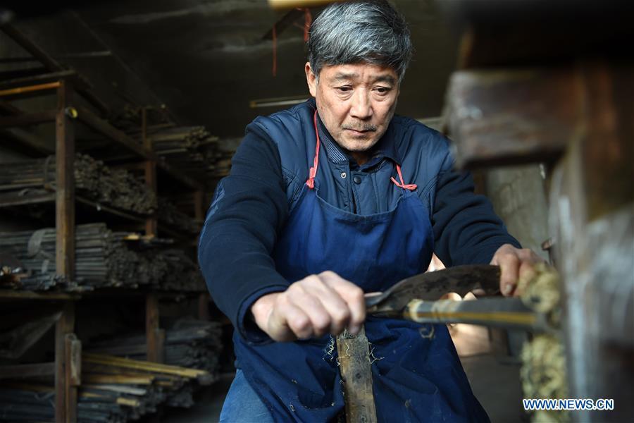 Liu Zesong, inheritor of the Yuping bamboo flute making craft, deals with bamboo materials for making a flute in Yuping Dong Autonomous County, southwest China\'s Guizhou Province, Nov. 29, 2018. As a traditional Chinese bamboo instrument, Yuping bamboo flute is famous for its clear tone and delicate carving. Made from local bamboo, the flute goes through dozens of procedures before finished and merges folk cultures of other ethnic groups. It was listed as one of the National Intangible Cultural Heritages in 2006. (Xinhua/Ma Ning)